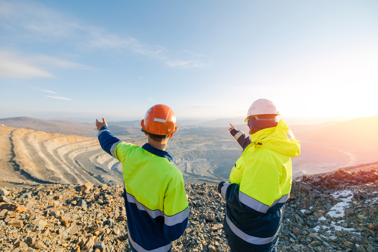 Mining Engineers Worker on Open Pit Quarry Overlooking Ore Mine, Back View